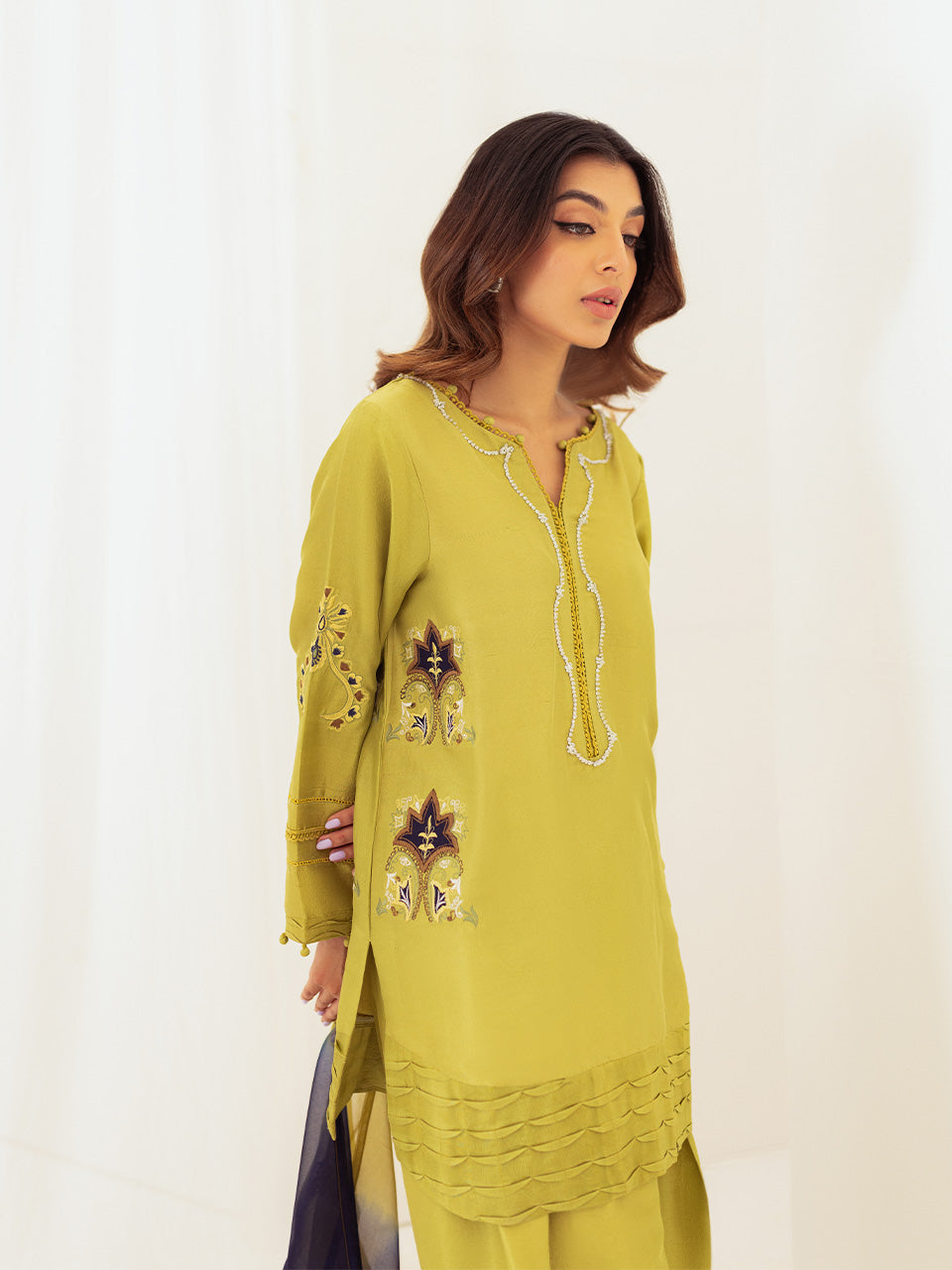 featuring bold deep blue appliqués, intricate threadwork