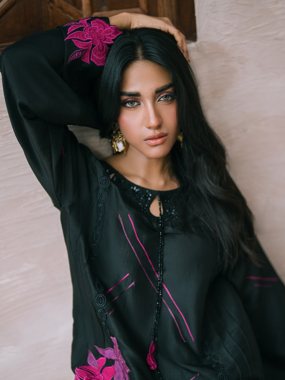 featuring vibrant fuchsia and plum appliqués, intricate embroidery, and handwork on the neckline