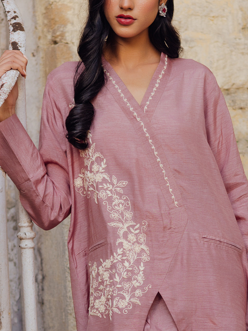 featuring intricate embroidery and delicate pearl embellishments