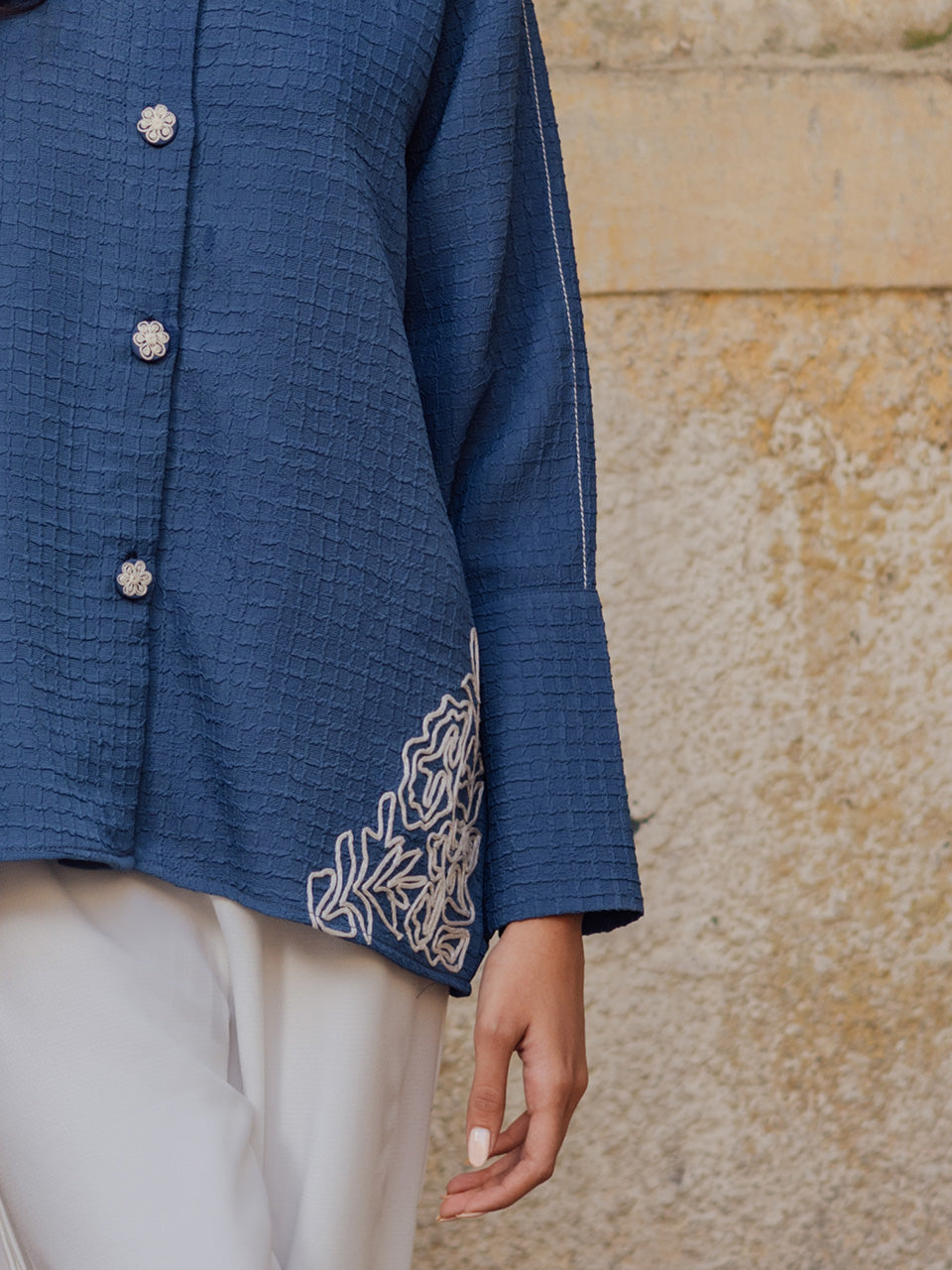 Deep blue tunic paired with pleated off white pants