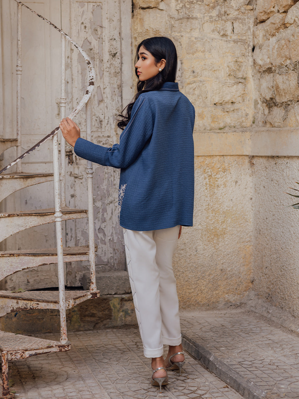 Deep blue tunic paired with pleated off white pants