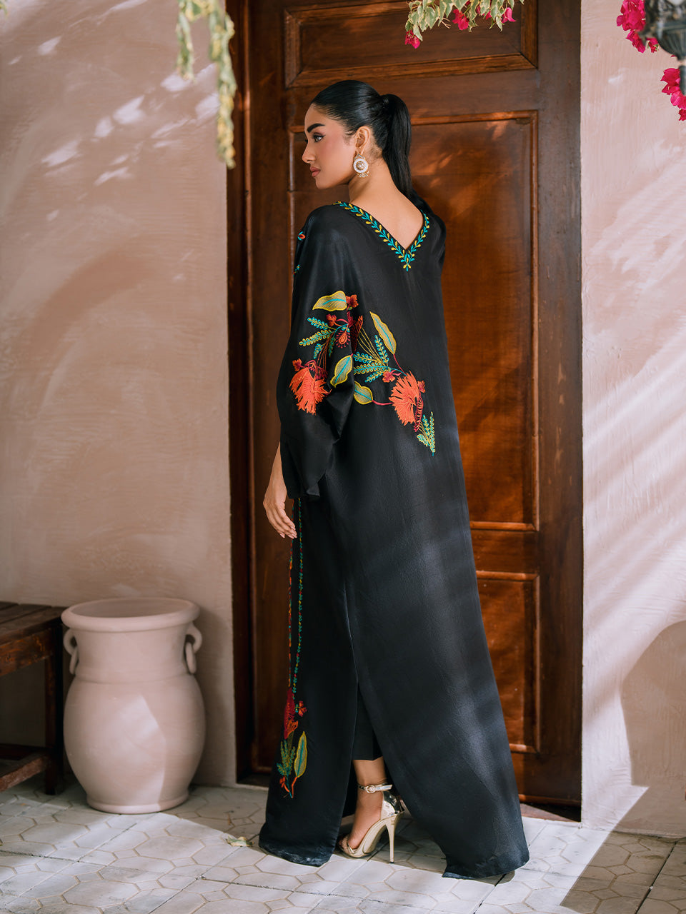 Maroon, orange, and green floral appliqué on black kaftan